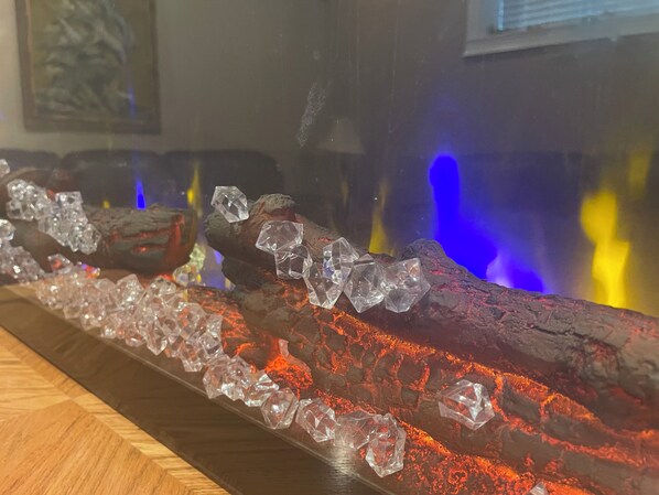 A decorative piece with clear crystals and a log, possibly part of a room's decor.