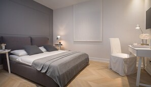 A modern bedroom with a bed, bedside table, chair, and a desk with a lamp. - Villa Vitomera - Modern villa with pool (Primosten)