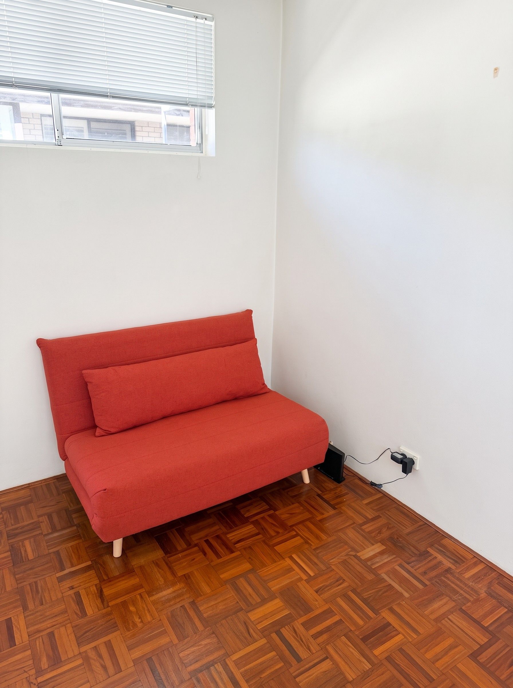 Red sofa in seating mode