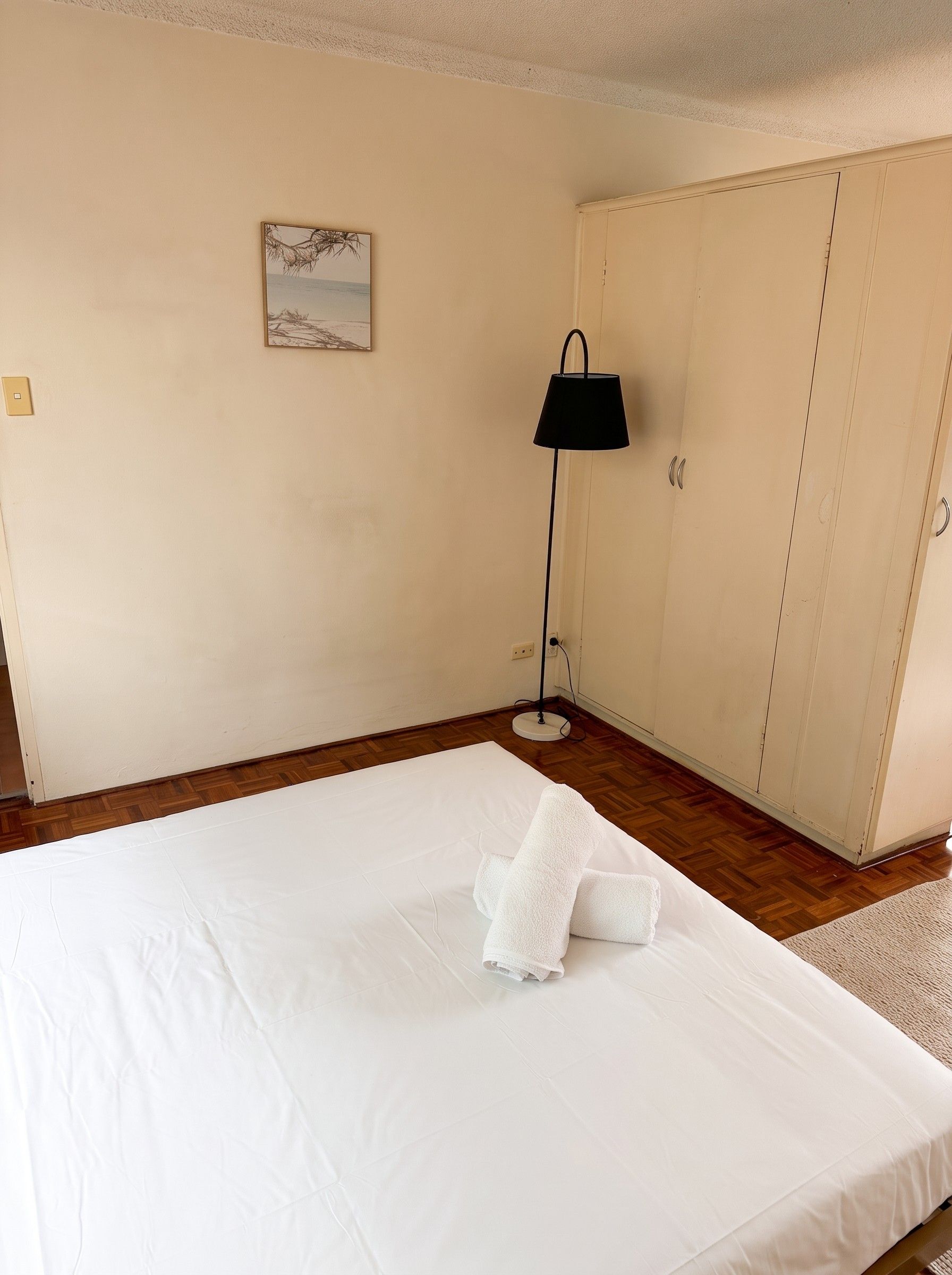 Bedroom with queen bed and built-in wardrobe