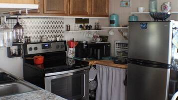 A kitchen with wooden cabinets, stainless steel appliances, and a granite countertop.
