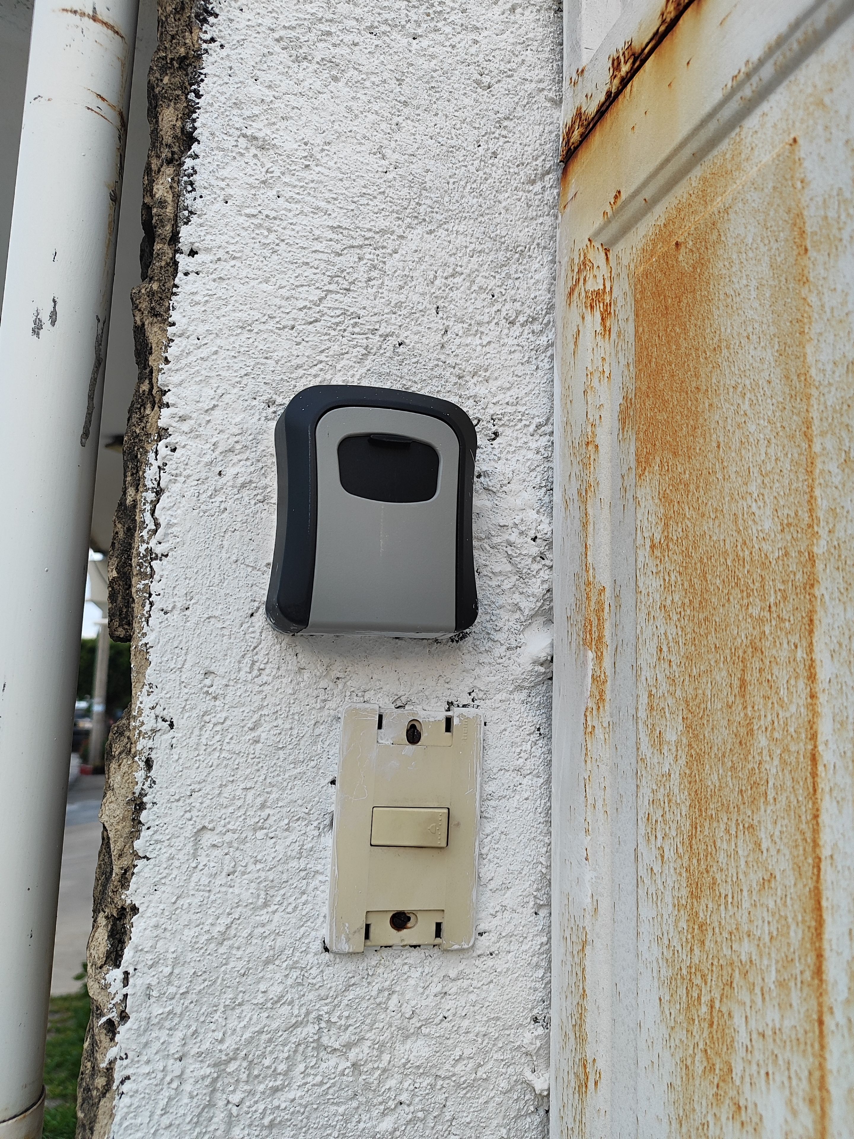A white wall with a rectangular electrical box and a smaller square switch box.