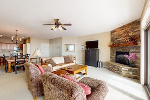 A living room with a fireplace, a ceiling fan, and a television. - Aerie Retreat | Mtn Views, Near Sugar Ski Resort (Sugar Mountain)