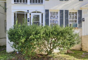 A residential building with a white facade, a number '327' on the door, and a small bush in the front yard. - Cloverdale Retreat 327 (Montgomery)