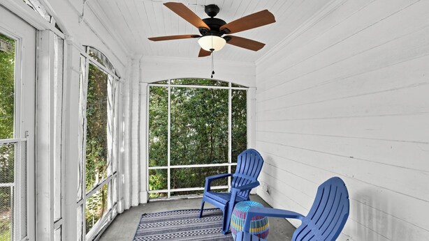 A porch with two blue chairs, a ceiling fan, and a view of greenery. - Mins to Downtown, Jackson Hosp., ASU, Maxwell AFB (Montgomery)