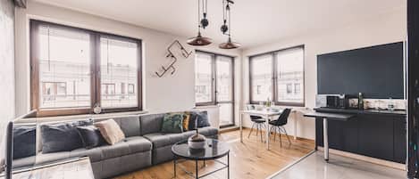 A modern apartment with a living area, dining space, and kitchen.