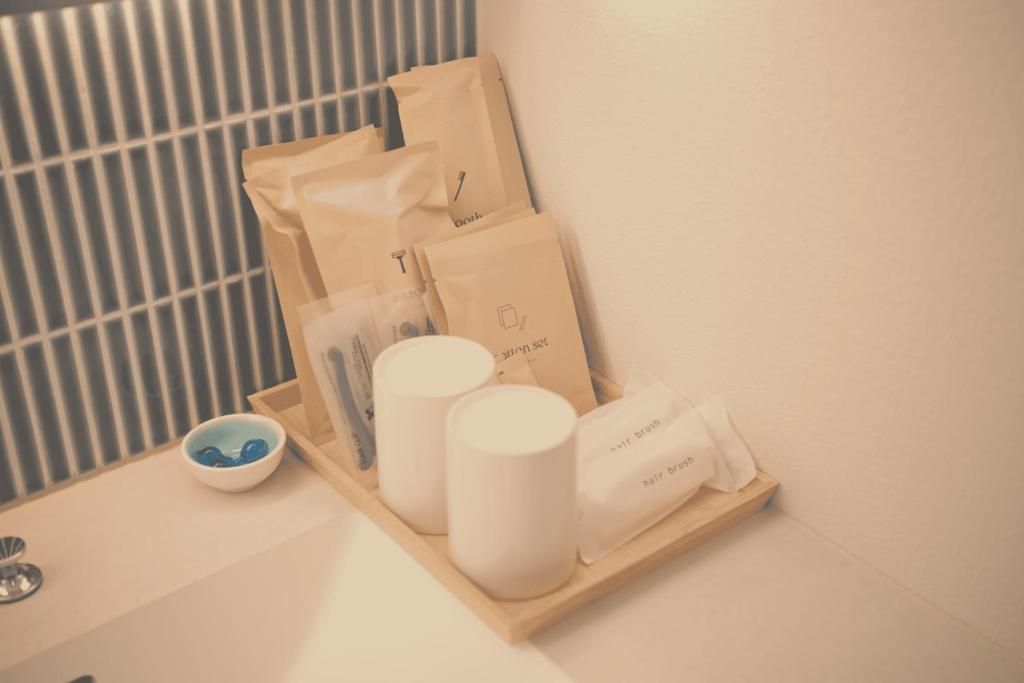 A bathroom with a wooden tray holding toiletries, a bowl of soap, and a towel.