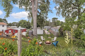 A residential area with houses, a fire pit, and outdoor seating. - Modern 3‑Bedroom Lake House with Gorgeous Water & Wildlife Views (Toledo)