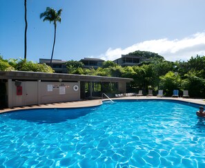 A swimming pool with a lifeguard stand, lounge chairs, and a palm tree. - Wailea Ekolu | 4BR | Sleeps 12 (Kihei)