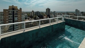 A rooftop swimming pool with a cityscape view, surrounded by high-rise buildings. - Venha conhecer este ape! - BE-DEO-403 (Maringá)