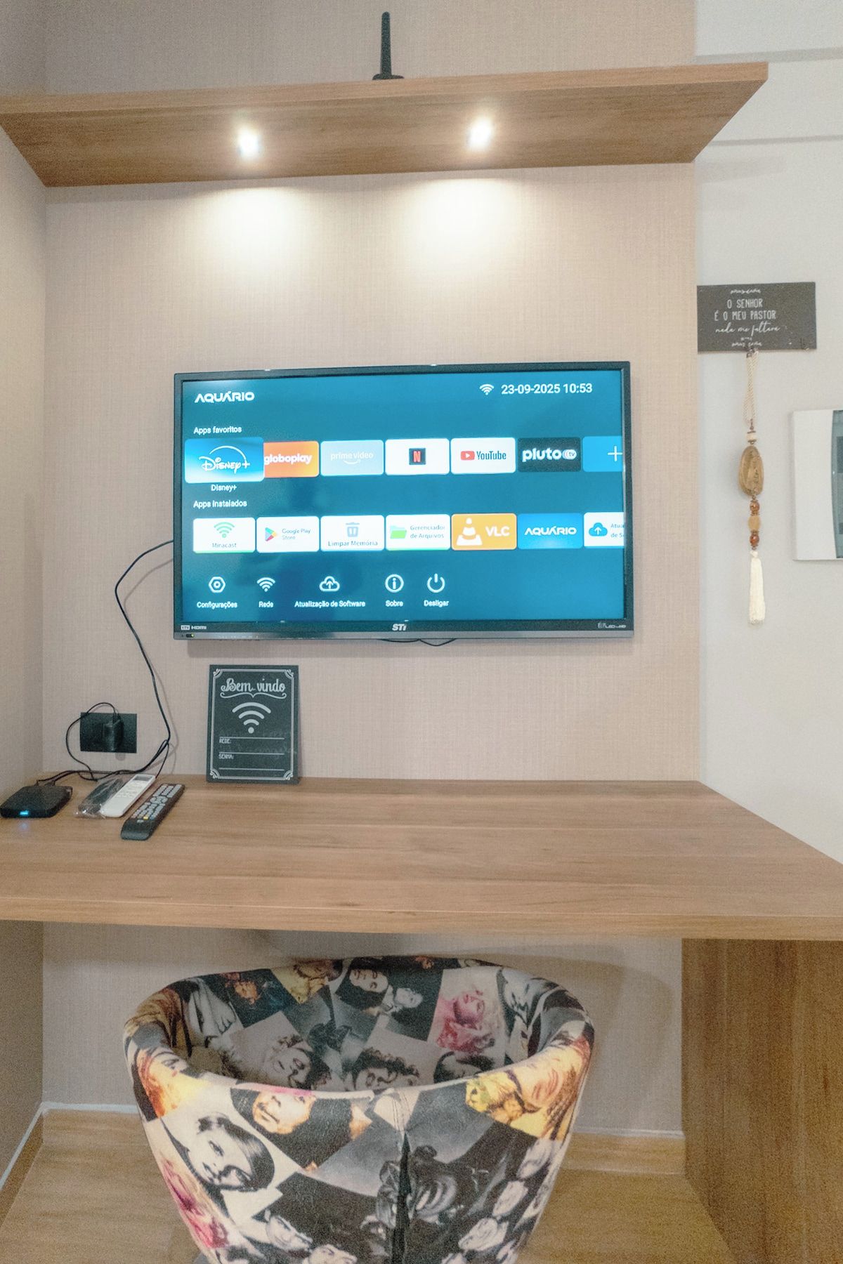 A television mounted on a wall displaying various streaming apps.