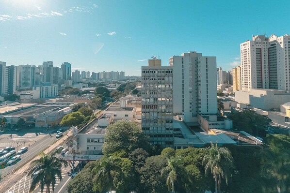 A high-rise building with multiple floors, surrounded by other tall buildings, in an urban setting.