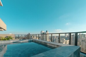A rooftop infinity pool with a cityscape view.