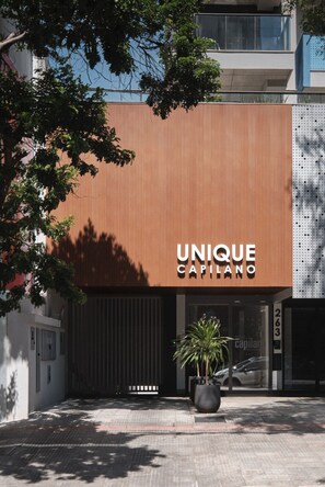 A modern building with a sign reading 'UNIQUE CAPILANO'.