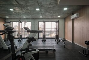 A gym with treadmills, a bench, and weight machines.