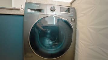 A Samsung digital washing machine in a compact kitchen setting.