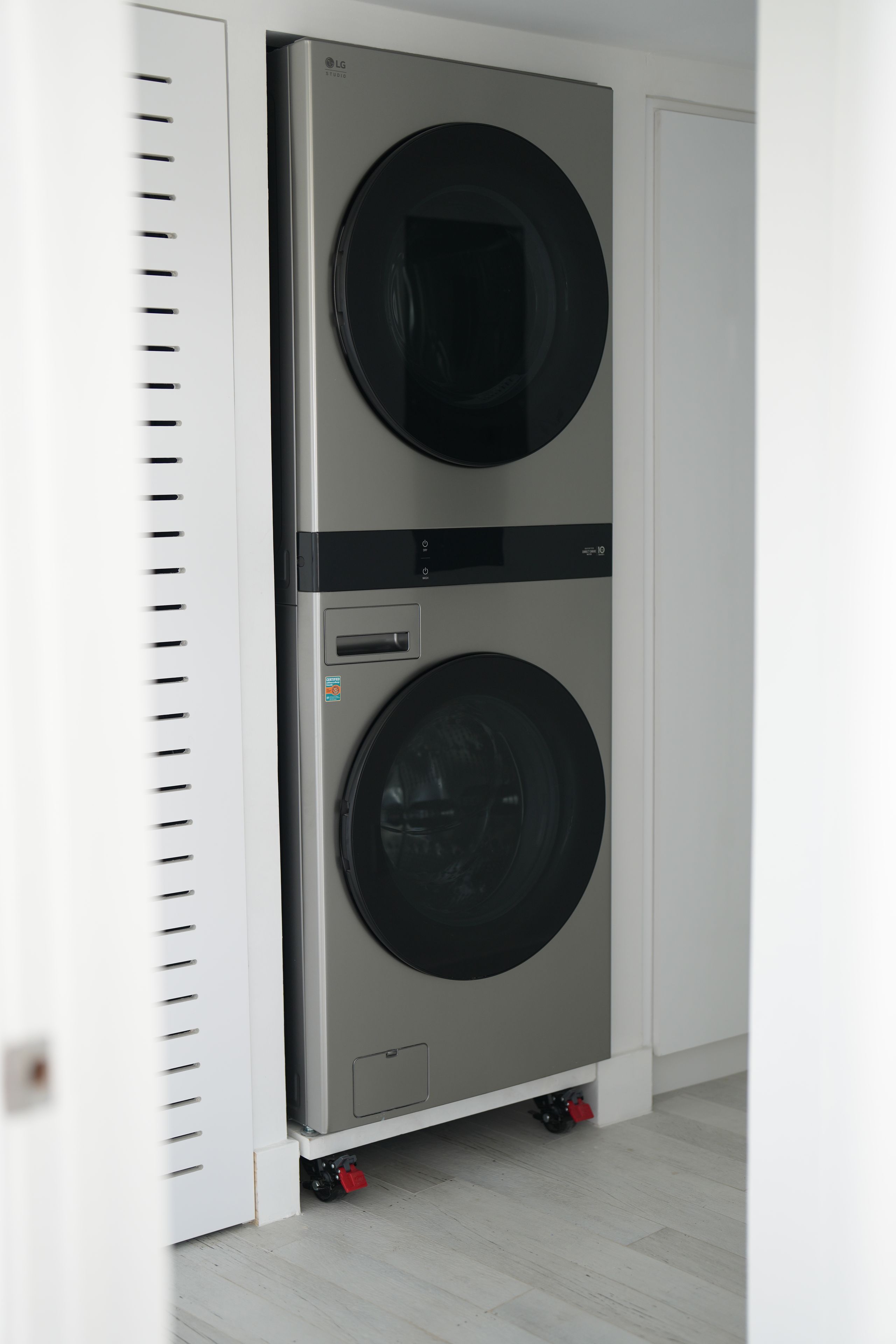 A double-door LG Studio washing machine with a control panel and a stainless steel finish.