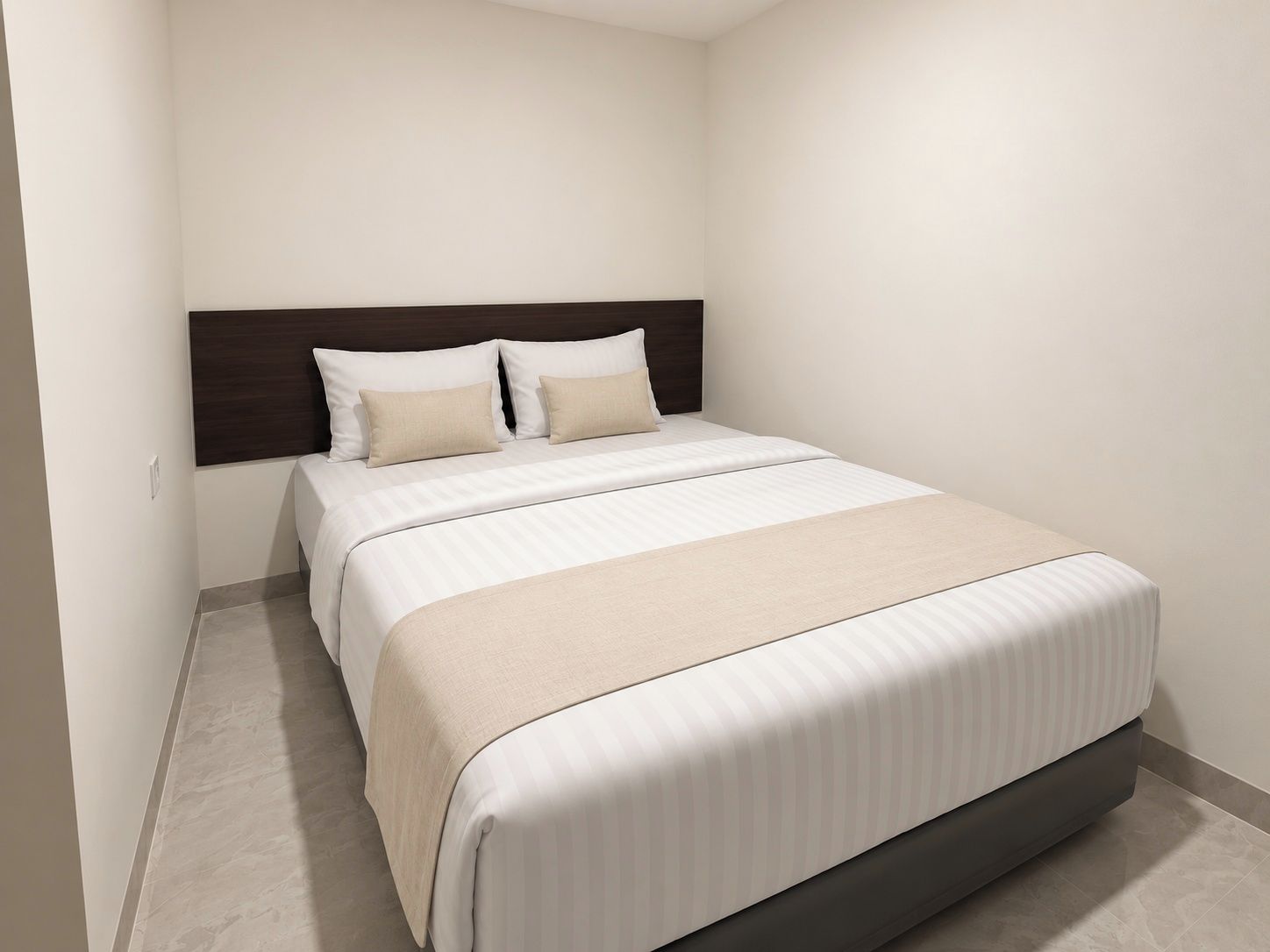 A hotel room with a bed, headboard, and a neutral color scheme.