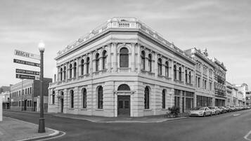 A historic building with classical architecture, including arched windows and decorative moldings.
