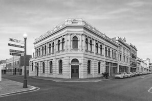 A historic building with classical architecture, including arched windows and decorative moldings. - The Mason (Fremantle)