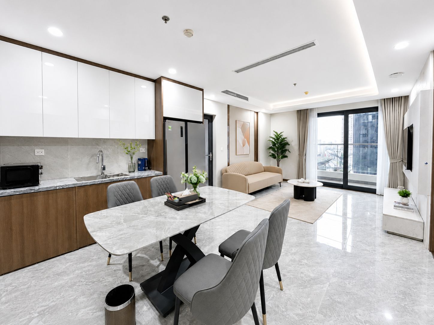 A modern apartment with a kitchen, dining area, and living room.