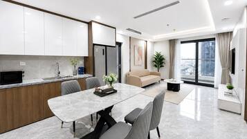 A modern apartment with a kitchen, dining area, and living room.