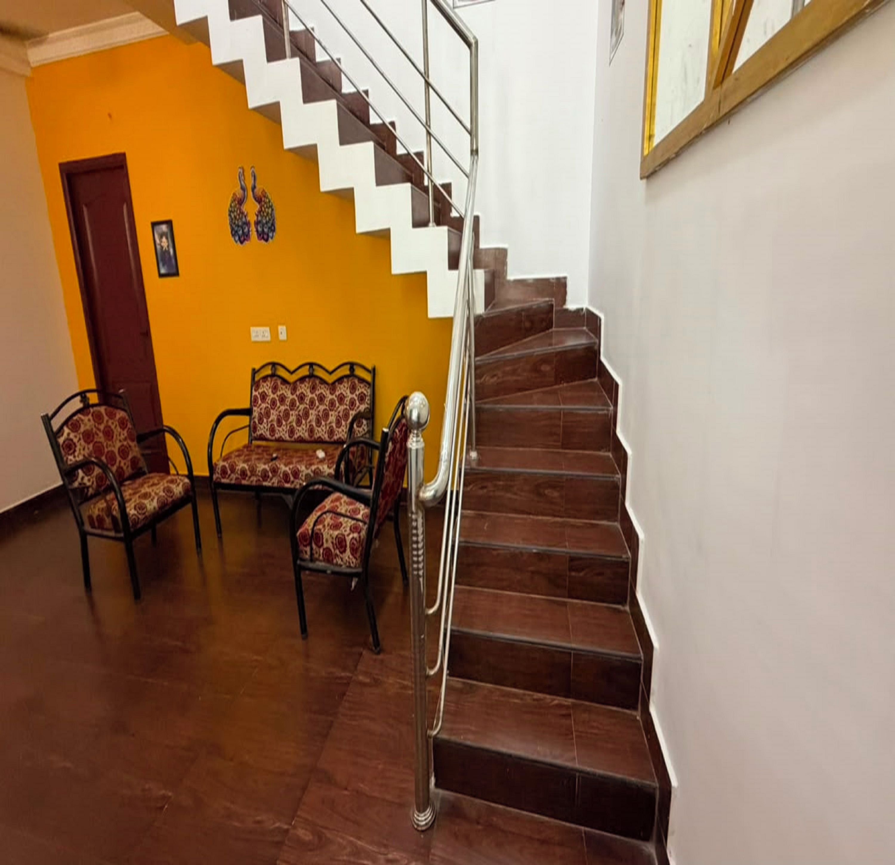 A staircase with a metal handrail leading to a landing.