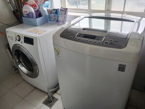 A laundry area with a front-loading washing machine and a top-loading dryer.