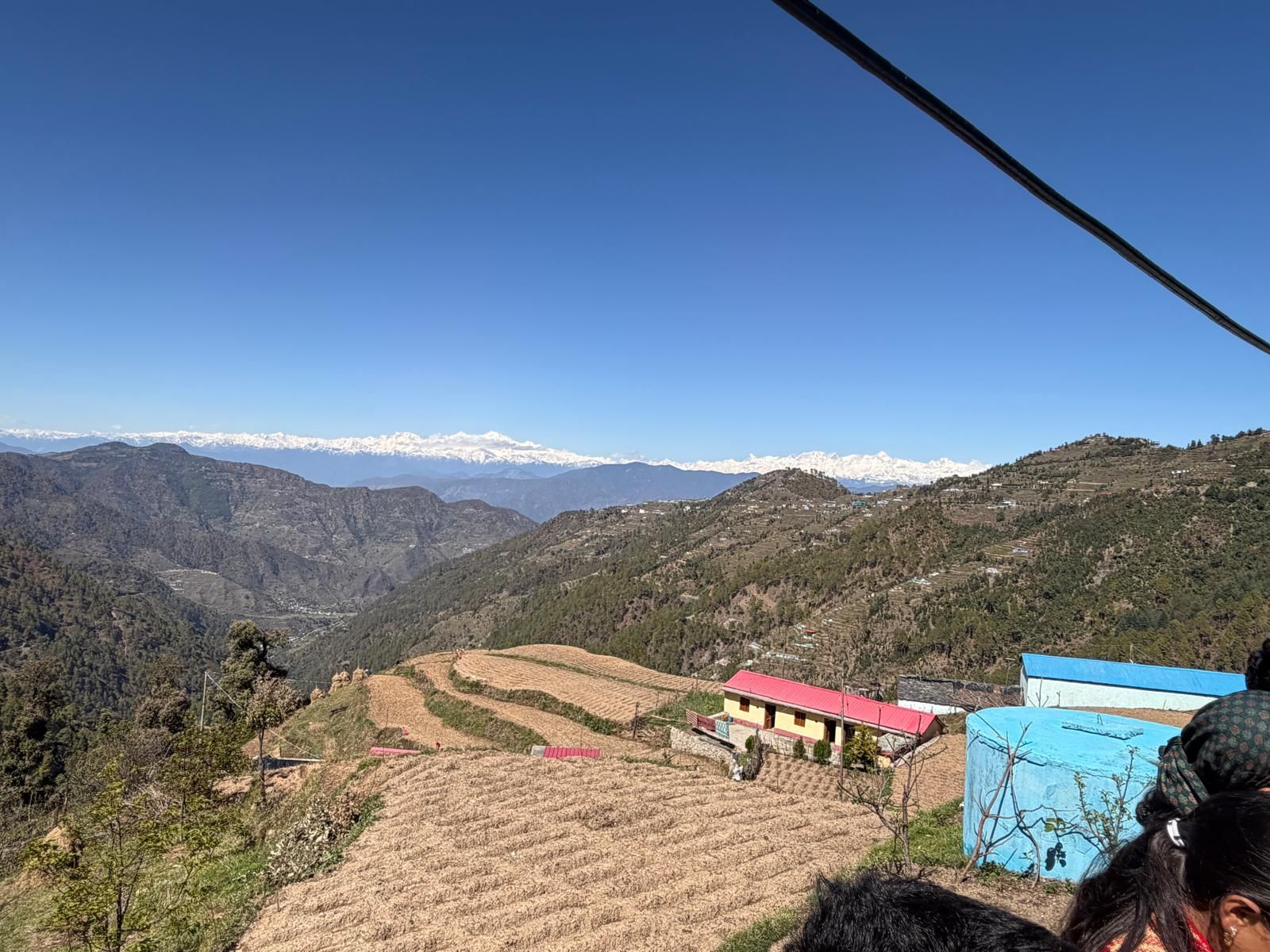 A mountainous landscape with terraced fields and a few buildings.
