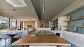 Eine moderne Küche mit Kochinsel, Bar und Essbereich mit Stühlen.