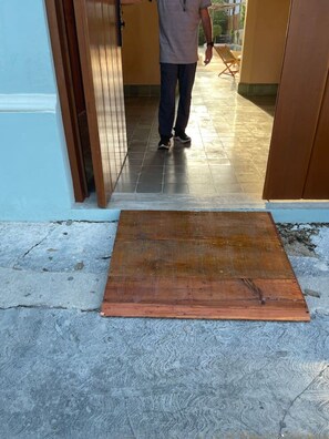 A person standing in a doorway with a wooden mat on the floor. - Colonial House w/5 studios + pool • A+ Location (Merida)
