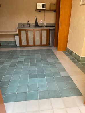 A kitchen with a tiled floor, wooden cabinets, and a built-in dishwasher. - Colonial House w/5 studios + pool • A+ Location (Merida)