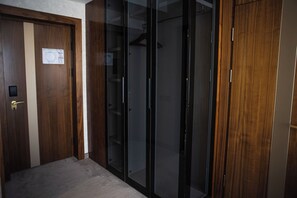 A room with a wooden door, a sliding glass door, and a carpeted floor.
