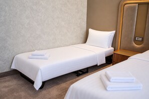 A hotel room with a single bed, a nightstand, and a wall-mounted control panel. - The Arte Hotel (Yerevan)