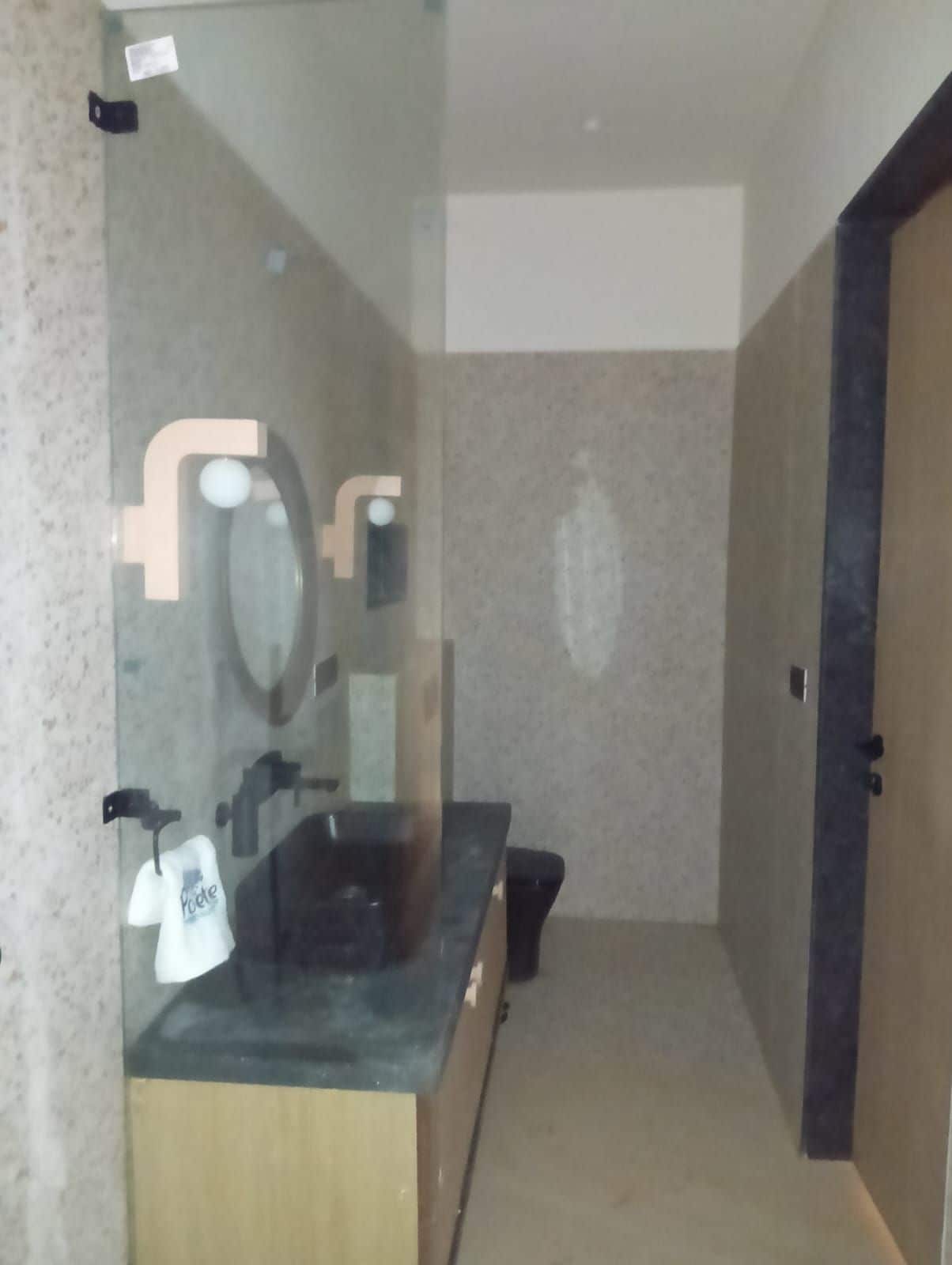 A bathroom with a mirror, sink, and towel rack.