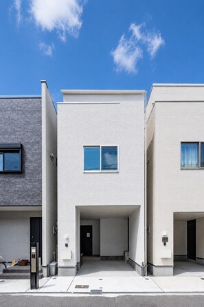A modern building with a flat facade, two visible windows, and a covered entrance. - Nikyo HARANAGI Villa Osaka (Osaka)