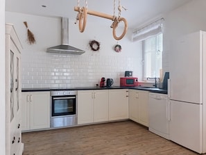 A kitchen with white cabinets, a stainless steel oven, a microwave, and a dishwasher. - Apartment V&D 0 by Interhome (Rokytnice nad Jizerou)