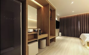 A modern hotel room with a bed, a desk, a wardrobe, and a bathroom area. - Hotel RIL (Gwangju)