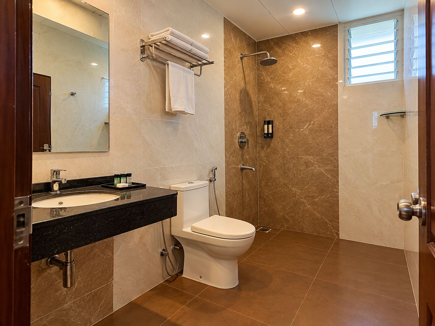 A bathroom with a sink, toilet, and shower.