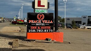 A motel sign with 'Peace Villa Motel' and 'Vacancy' displayed, along with a contact number. - Peacevillamotel (Dawson Creek)