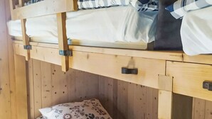 A bunk bed with a lower bunk and a top bunk, both with checkered bedding. - Les Fougères by Interhome (Champoz)