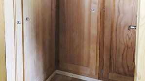A wooden wardrobe with a handle and a lock. - Les Fougères by Interhome (Champoz)