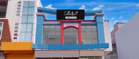 A building with a sign that reads 'Collection' and 'YO-Serviced'.