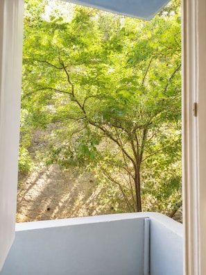A room with a view of a tree through a window. - 3BR Istanbul Apartment In Historic Balat + Golden Horn Views (Istanbul)