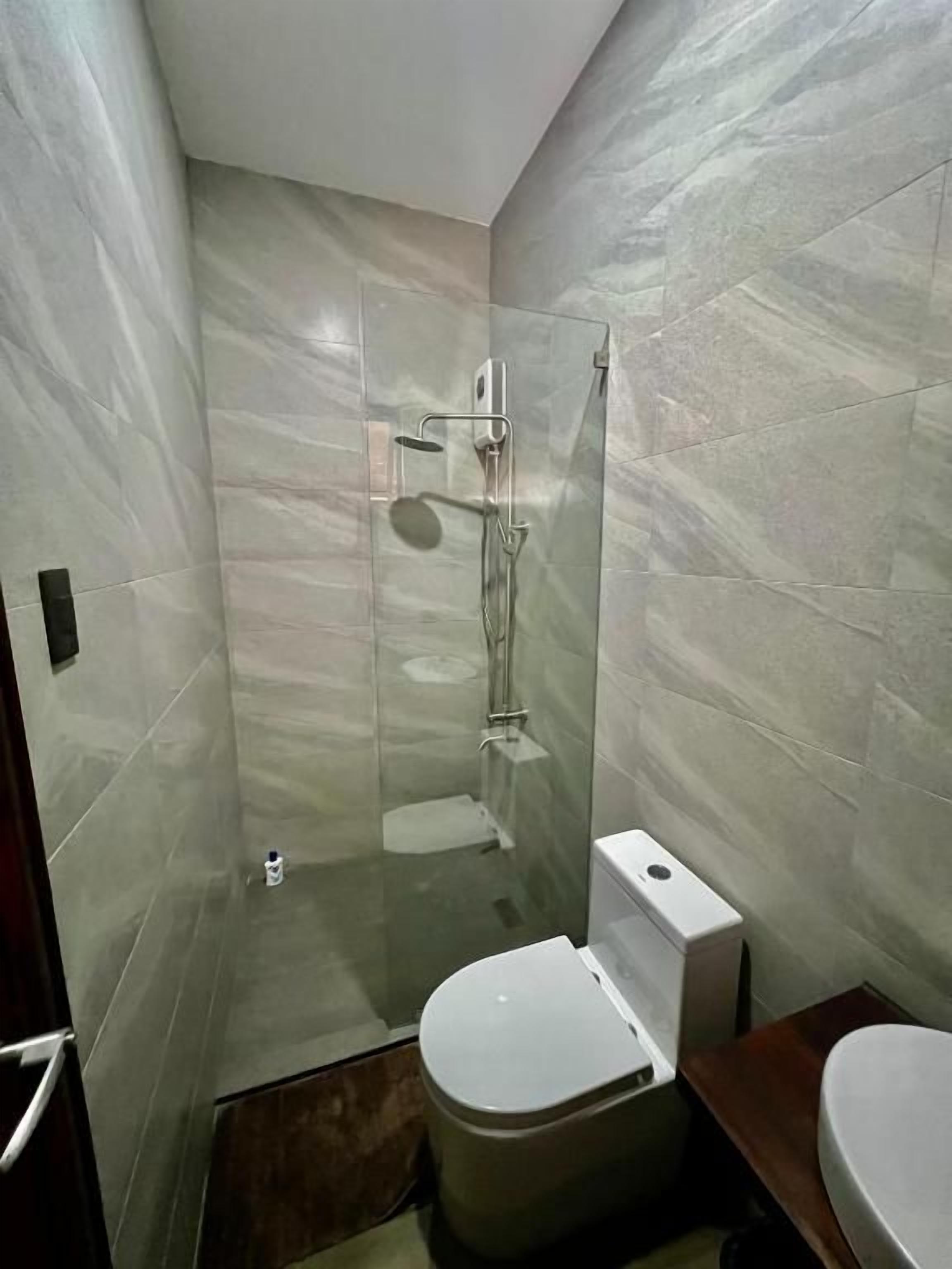 A bathroom with a shower, toilet, and sink.