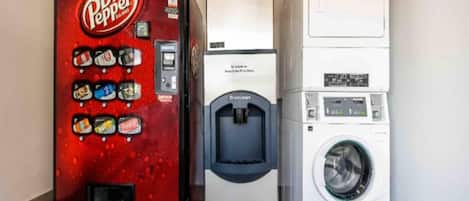 A vending machine, a water dispenser, and a washing machine in a room.