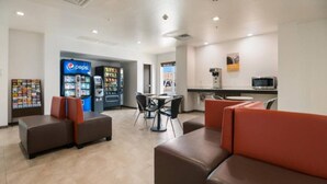 A lobby with seating areas, a vending machine, and a kitchenette. - 1 King Bed|Hearing Accessible,Kitchen (Corpus Christi TX)
