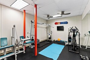 A gym with exercise equipment, a blue mat, and a ceiling fan. - Log Home • Hot Tub + Full Gym | Ski-in/out Funicular | 115 Tristant (Mountain Village)