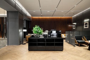 A modern reception area with a central console, seating, and a coffee station. - IntercityHotel Shenzhen North Yifang (Shenzhen)