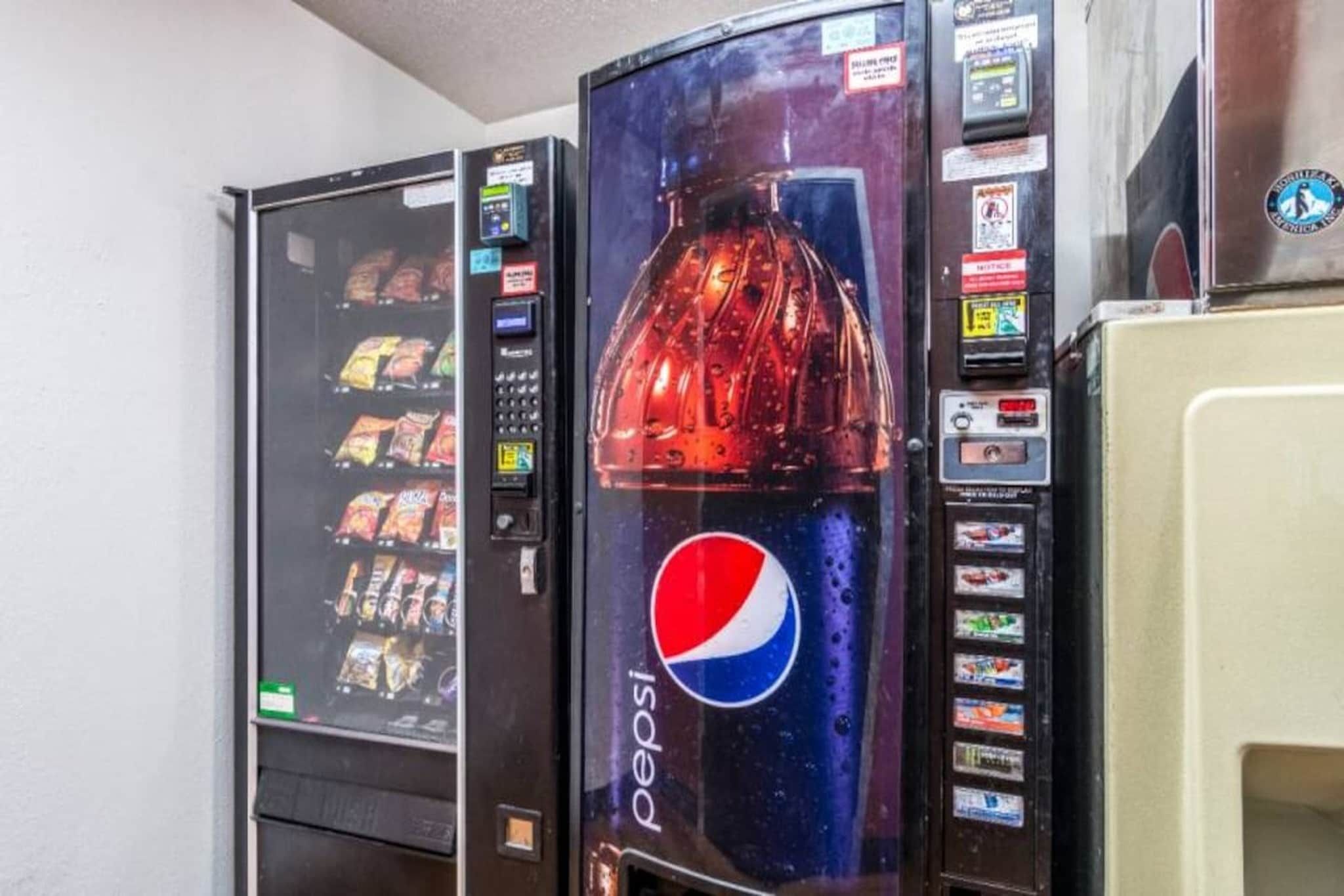 Ein Getränkeautomat mit Pepsi-Logo, einer Auswahl an Snacks und einer Bezahleinheit.